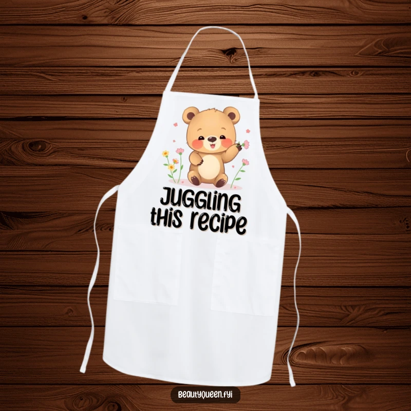 Funny apron showing a small bear cub clumsily juggling tiny blooming flowers while cooking.
