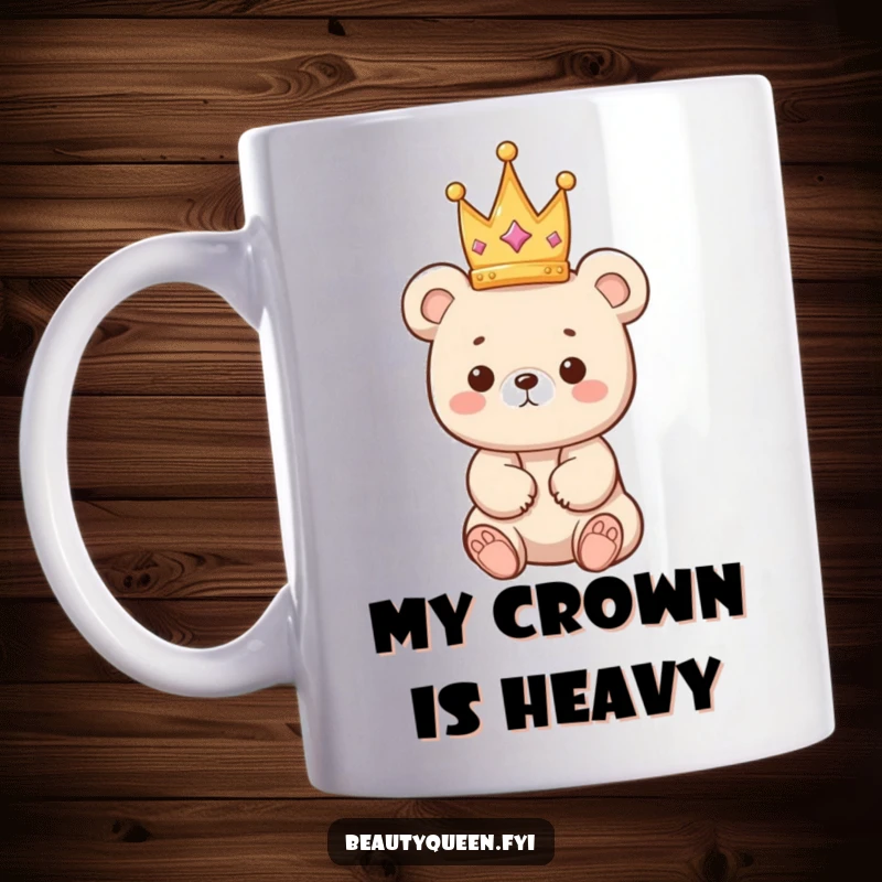 Funny bear mug showing a kawaii bear cub precariously balancing a tiny crown on its head with a cute expression.