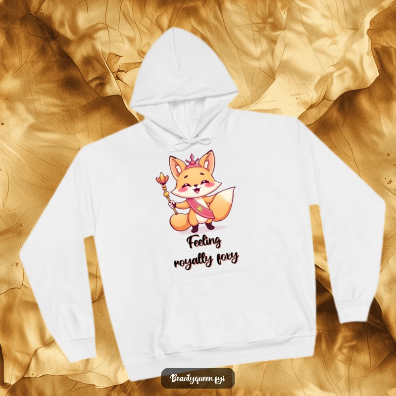 Funny hoodie depicting a giggling fox in a shimmering sash, striking a triumphant pose with a scepter, embodying regal amusement.